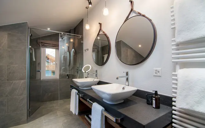 Suite with bath and shower at Walliserhof Grand-Hotel & Spa, Saas-Fee