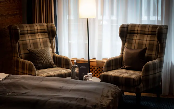 Comfortable seating area in a Classic single room at Walliserhof Gand-Hotel & Spa, Saas Fee